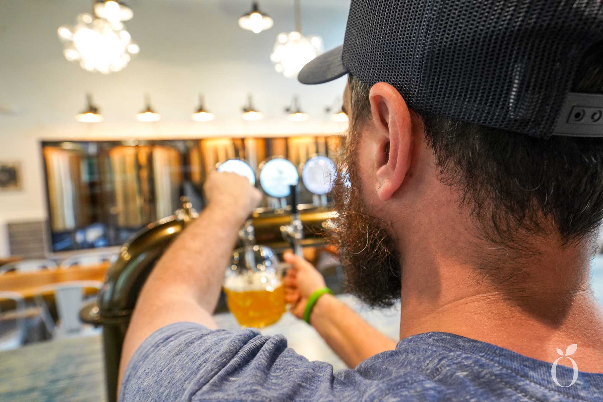 Andy McGhee, Co-owner of Windermere Brewing, pours a beer